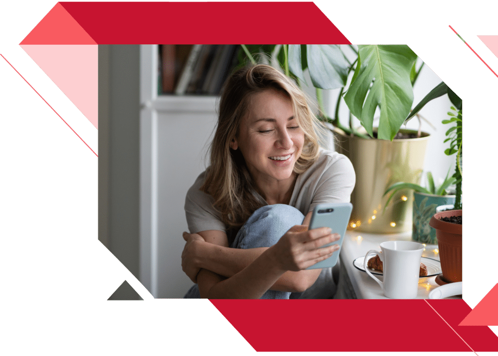 young female browsing her phone in her bedroom